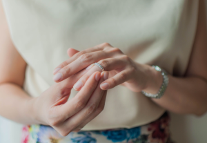 A close up of a person with their wedding ring in hand. This could represent the beginning of an emotional divorce that a divorce coach near Tampa, FL can help you navigate. Learn more about divorce coaching in Florida and other services like life transitions coaching today.
